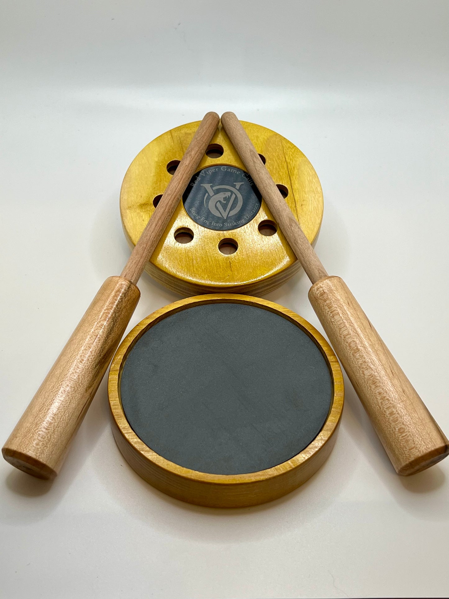 Osage Orange Pot Call. Up close with Red Viper Game Calls logo and slogan “Bring ‘em Into Striking Distance” engraved on an anodized aluminum coin that is inlayed in the center of the call. Great looking and sounding turkey call.