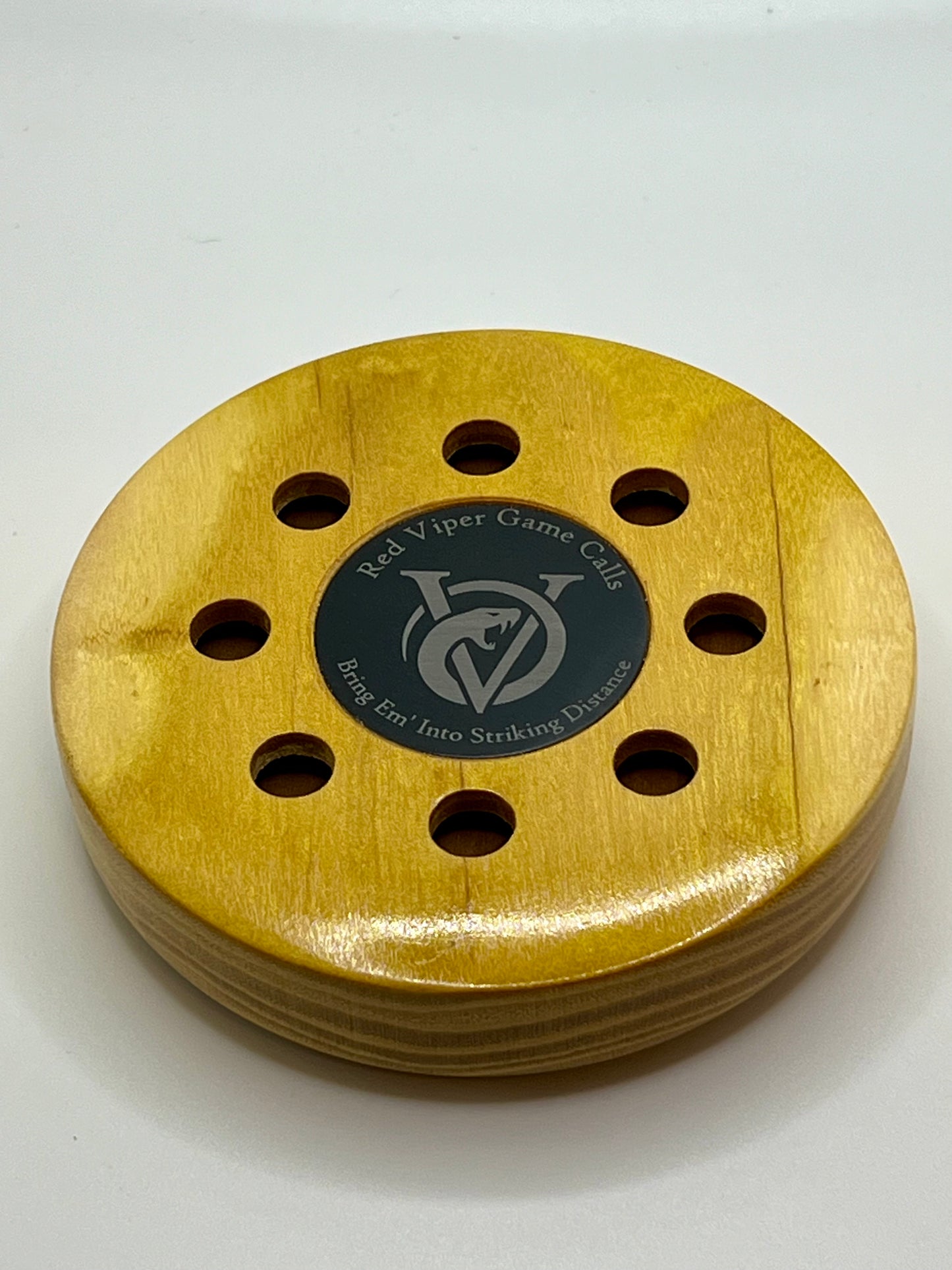 Osage Orange Pot Call. Up close with Red Viper Game Calls logo and slogan “Bring ‘em Into Striking Distance” engraved on an anodized aluminum coin that is inlayed in the center of the call. Great looking and sounding turkey call.